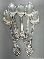 Five sterling silver souvenir spoons front view