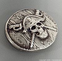 Obverse showing skull design and wood-grain texture