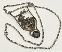 Pendant and chain laid out fully