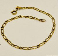 Full view of gold chain bracelet laid flat