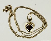 Chain coiled with heart pendant visible