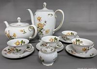 Full set showing coffee pot, teapot, sugar bowl, cups and saucers
