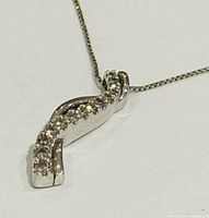 Pendant close-up showing stone setting and gold finish