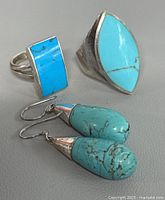 Group shot of both rings and earring pair showing turquoise stones and silver settings