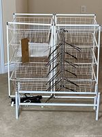 Front view of both storage towers with baskets, disassembled shoe rack pieces and hangers visible