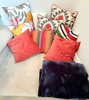 All cushions and folded blanket grouped on carpeted stair landing