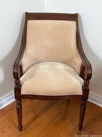 Front view of upholstered barrel-back accent chair