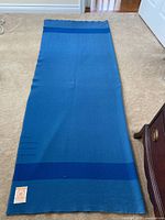 Full view of blue Hudson's Bay wool blanket laid flat