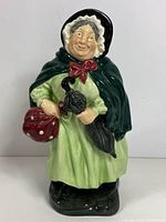 Front view of Royal Doulton Sairey Gamp figurine showing full attire and accessories