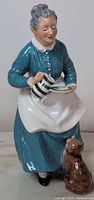 Full view of Royal Doulton figurine showing woman, mug, saucer, cat