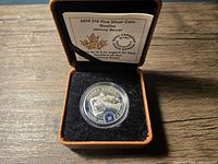 Coin in open presentation case with info card