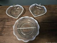 Three Anchor Hocking Moonstone hobnail dishes: one divided relish dish, two bonbon dishes