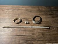 Full set laid out: choker, bracelet, earrings, hair tie