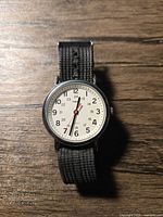 Front view showing dial, numerals, strap and overall condition