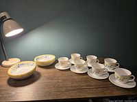 Full set of cups on saucers with stacked fruit bowls