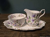 Set of creamer, sugar bowl and underplate showing pattern and form