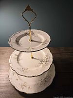 Top-down view of assembled three-tier Royal Albert Haworth dessert stand showing floral pattern and gold trim