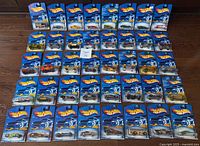 All 40 sealed 2002 Hot Wheels cars laid out in five rows of eight
