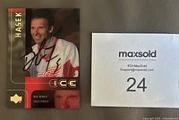 Front of autographed Dominik Hasek Upper Deck Ice card beside lot number card