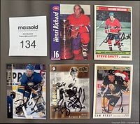 Five autographed cards including Henri Richard, Steve Shutt, Dominik Hasek, Ray Bourque, Cam Neely with MaxSold lot tag