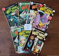 All seven comics spread on wooden floor