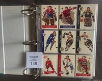 Binder open showing nine of the Parkhurst reprint hockey cards in plastic pages