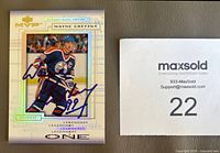Front of autographed Wayne Gretzky card next to MaxSold lot tag