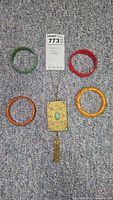 All items: gold tone purse pendant and four bangles arranged together