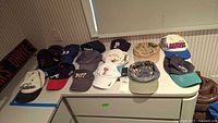 All 15 baseball caps laid out on countertop