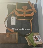 Group shot: Dooney & Bourke purse on brand dust bag, Gucci wallet, green Italian wallet