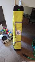 Full view of yellow E-Z Up carry bag standing upright