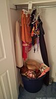 Closet rod with hanging costumes, barrel below
