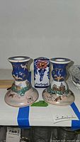 Two hand-painted ceramic candle holders with Portugal bud vase