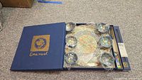 Emanuel presentation box open showing Seder plate and six bowls wrapped