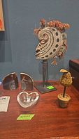 Group shot showing heart dish, geodes, tribal mask on stand and pear decor