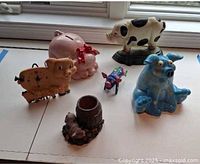 Group view of six pig-themed items on table
