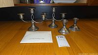 Front view of all candle holders and polishing cloth