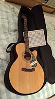 Full view of guitar in gig bag with guide sheet