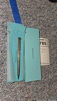 Pen in open Tiffany box with pouch visible