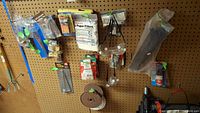 Overall pegboard showing majority of packaged hardware and tools