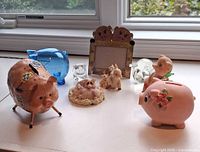 All pig items arranged on windowsill