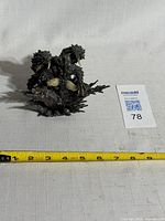 Top view of entire Nergigante figure with measuring tape showing width