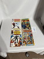 Four Iron Man related comics laid out
