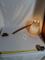 Full view showing teak arm, wall mount block, conical shade and tape measure