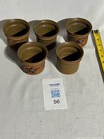 View of all five Edward Drahanchuk stoneware cups side by side