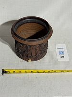 Front view of signed Edward Drahanchuk stoneware planter with tape measure for scale