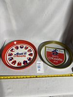 Both metal trays side by side with measuring tape