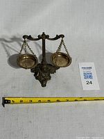 Front view of brass scale with tape for width reference