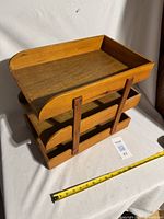 angled front view showing three tiers and curved upper tray edge