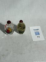 Both snuff bottles side by side with lot card visible